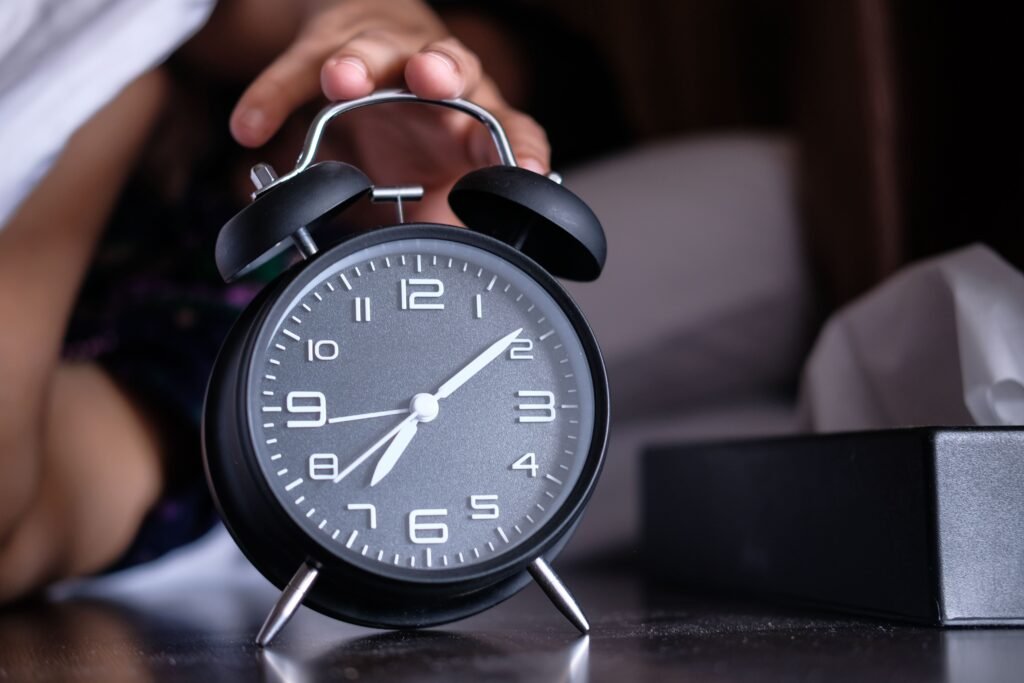 Person turning off an alarm clock as part of a life reset routine
