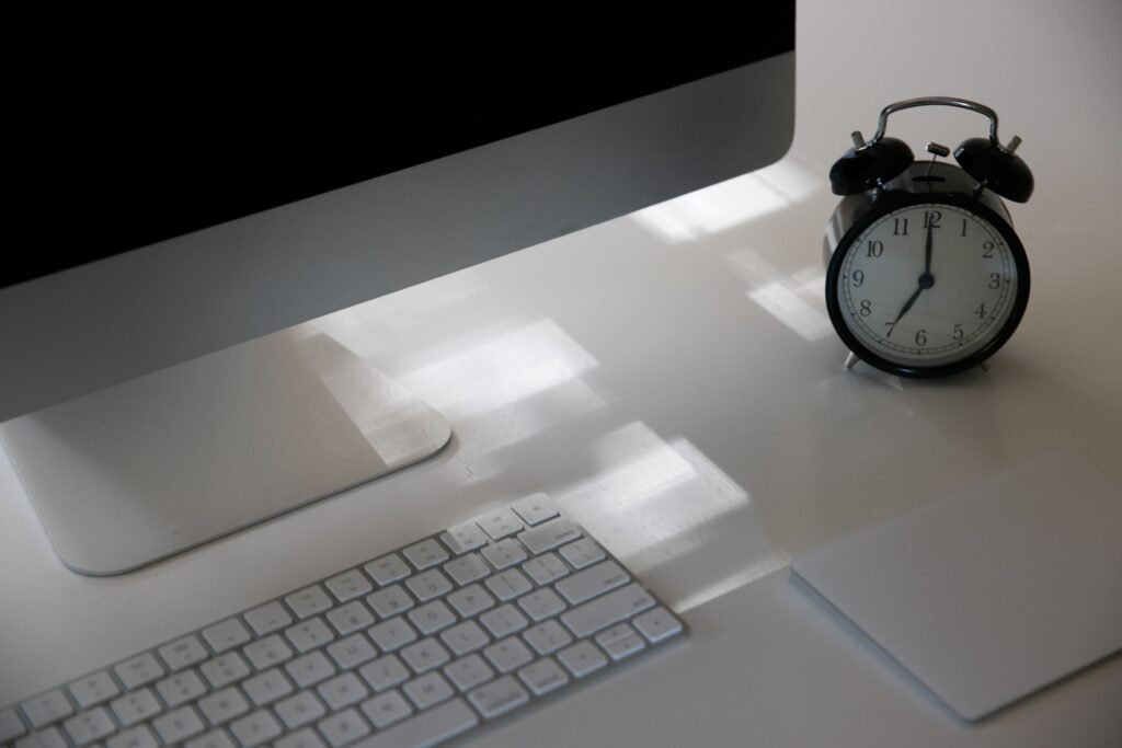 smartphone screen time and clock on a desk